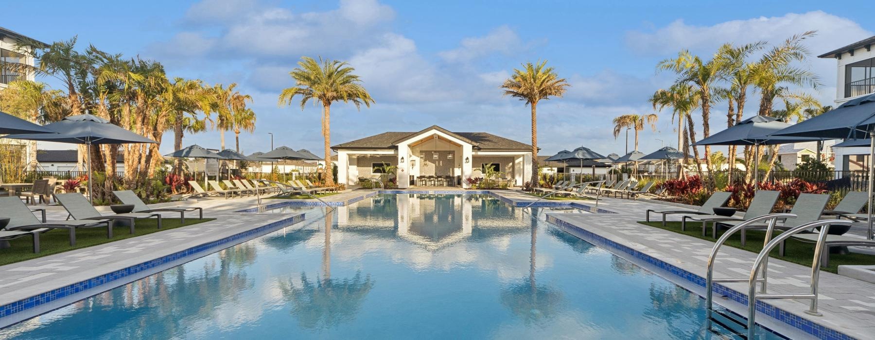 a pool with lounge chairs around it