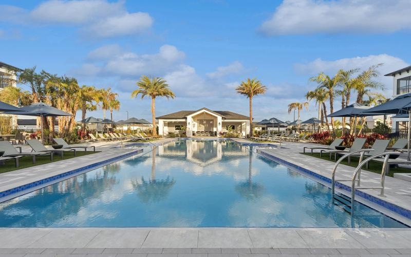 a pool with lounge chairs around it